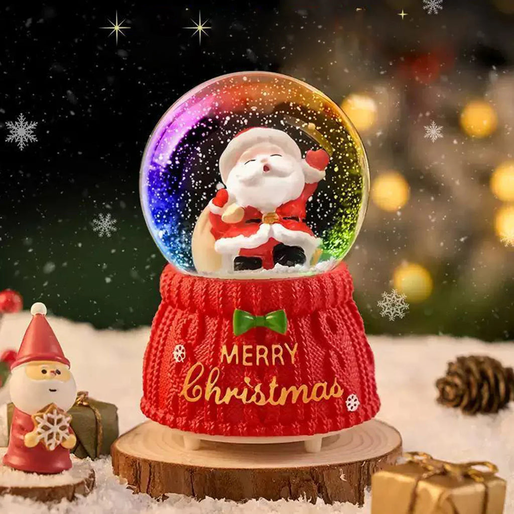 Santa Snow Globe - Magical Christmas Decoration with Santa carrying a sack inside a glowing globe on a red knitted base, enhancing holiday spirit.